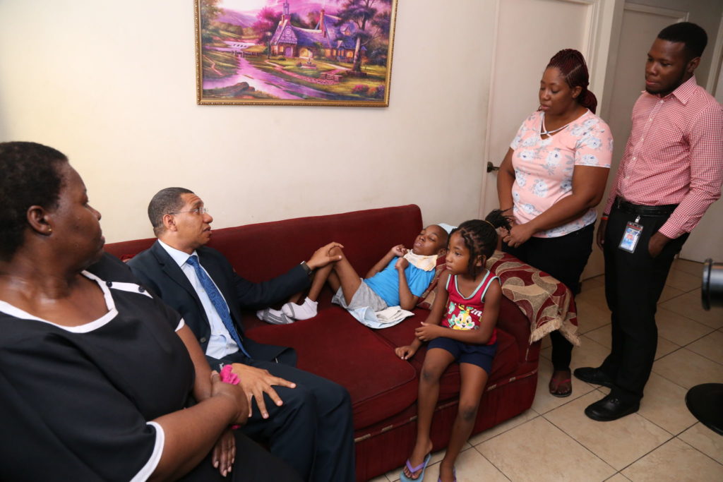 PM Holness Moved by Story of Tahj Rowe and Makes Personal Donation